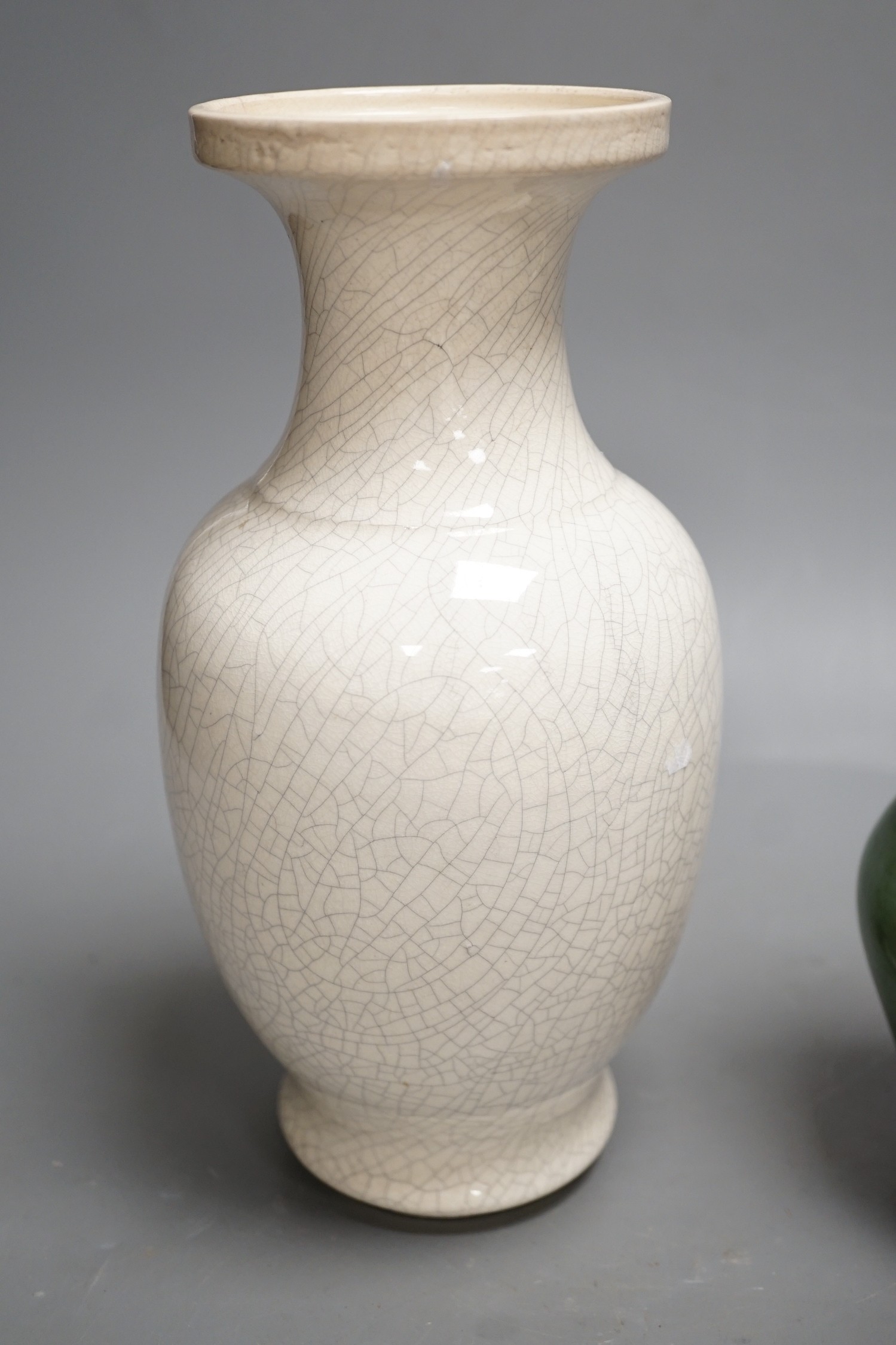 A Chinese white crackleware vase and a smaller green glazed vase